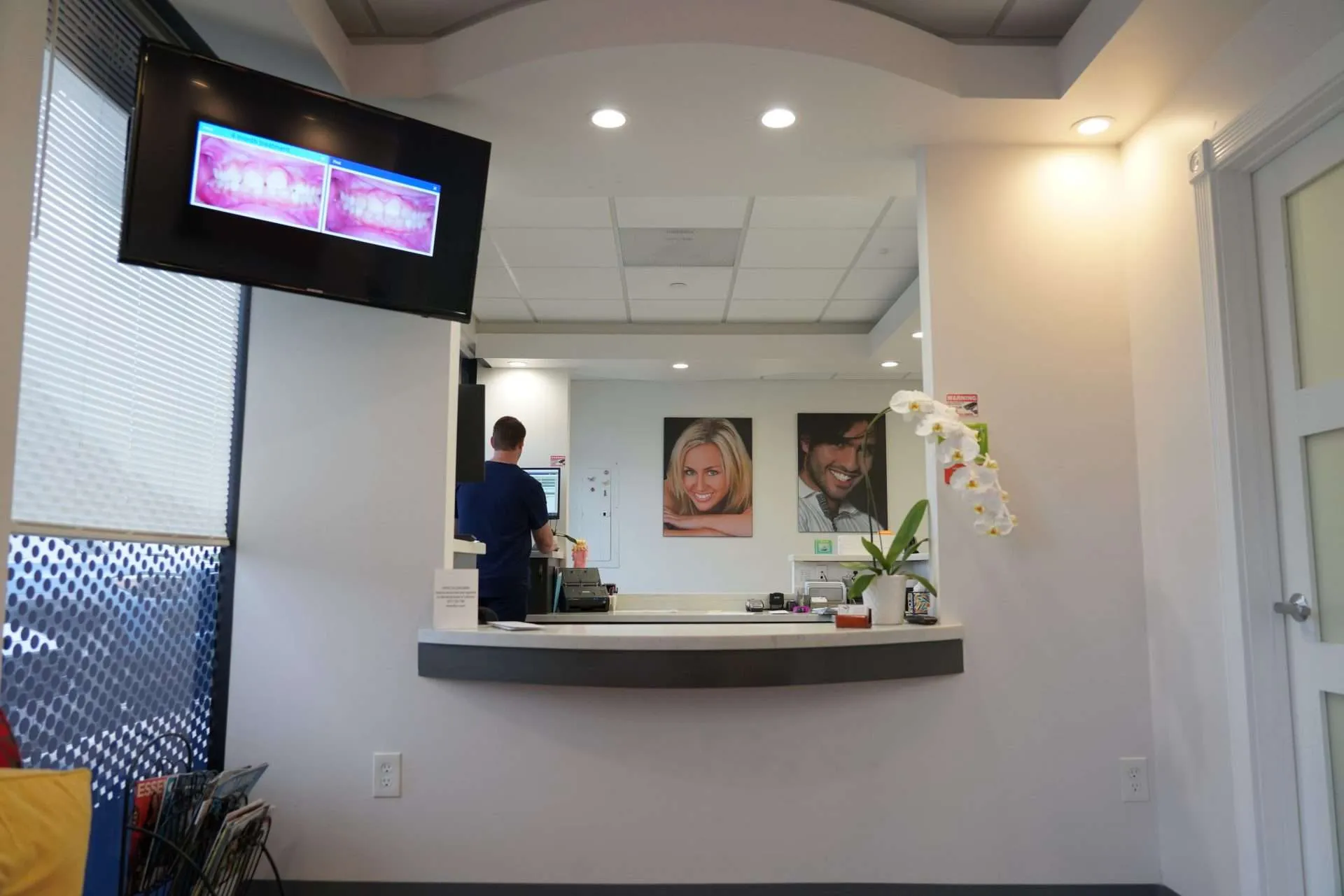 saddleback dental associates A man standing behind a counter in a dental office